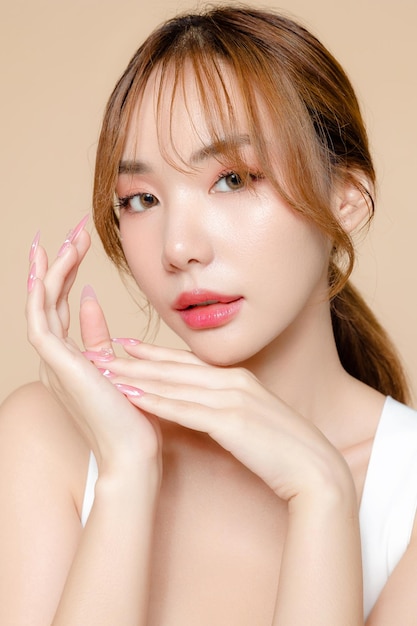 Young Asian beauty woman model pony tail hair with korean makeup style on face and perfect skin on isolated beige background Facial treatment Cosmetology Spa Aesthetic plastic surgery