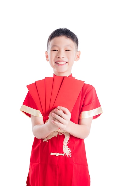 Young asian boy smiling while holding red packet 