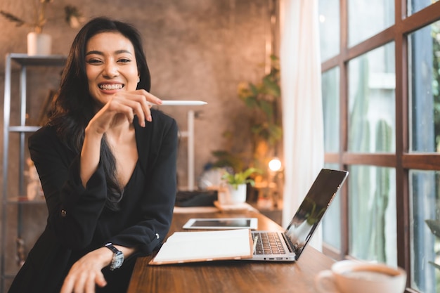 Young Asian business freelance woman using laptop computer to work on online cyberspace workplace female person in happy modern lifestyle businesswoman working in technology of digital remote office