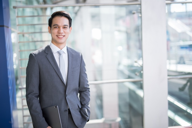 Young Asian business man holding a tablet 