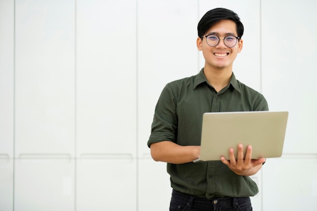 Young asian business man or student working online on computer laptop