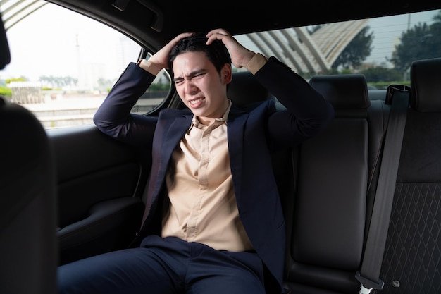 Young Asian business man with car