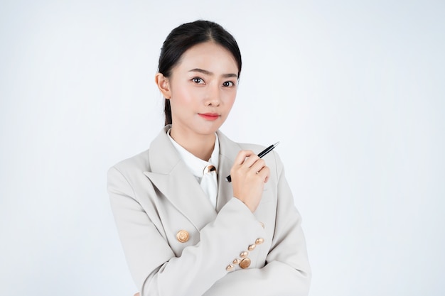 Young Asian business woman in grey suit, is smart and confident. Manager is thinking about work.