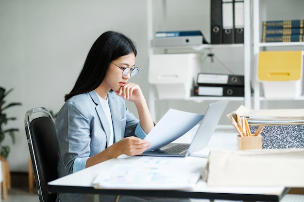 Young asian business woman or student working online on computer laptop