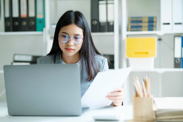 Young asian business woman or student working online on computer laptop