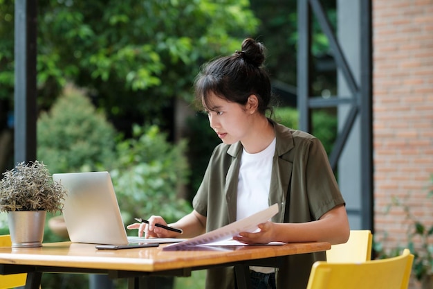 Young asian business woman or student working online on computer laptop