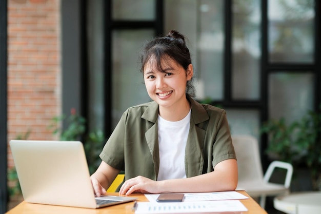 Young asian business woman or student working online on computer laptop