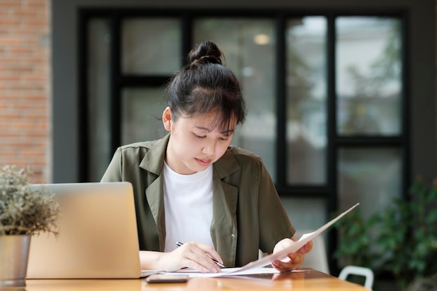 Young asian business woman or student working online on computer laptop