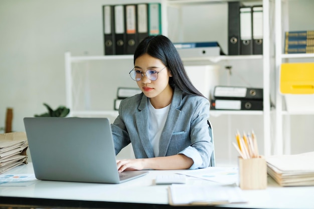 Young asian business woman or student working online on computer laptop