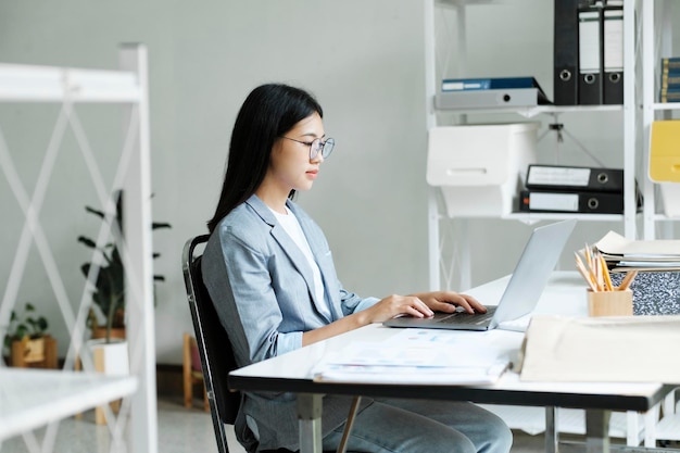 Young asian business woman or student working online on computer laptop