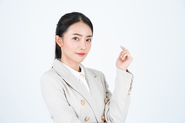 Young asian business woman in white shirt and beige suit