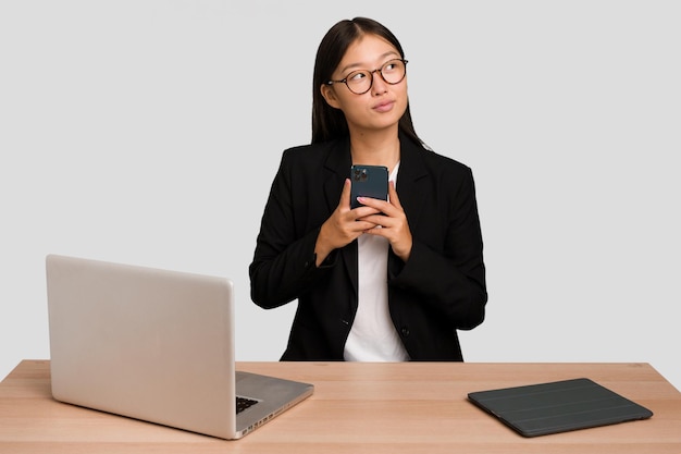 Young asian business woman working in his workplace isolated