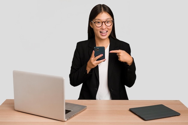 Young asian business woman working in his workplace isolated