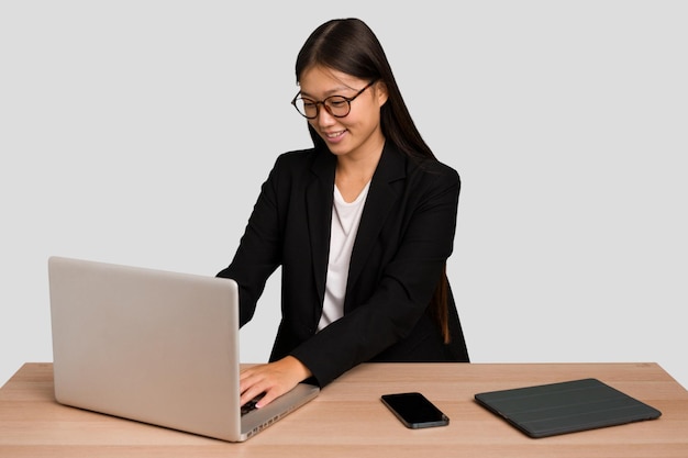 Young asian business woman working in his workplace isolated