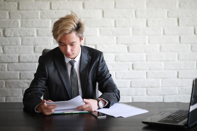 Young Asian businessman in classic white shirt and tie