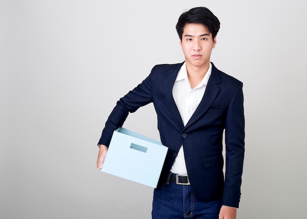 Young asian businessman holding a box