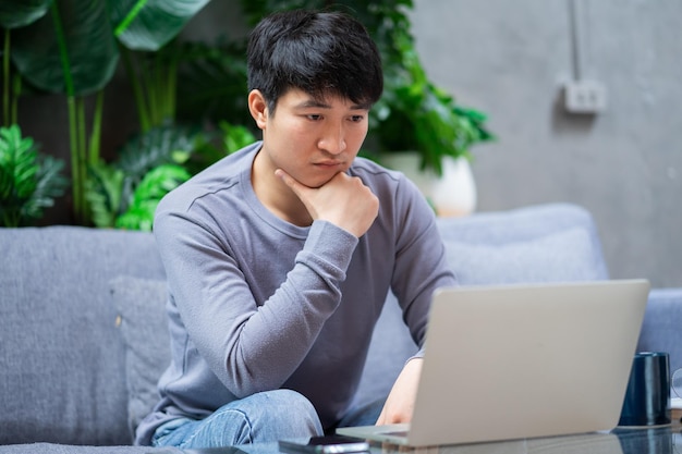 Young Asian businessman at home