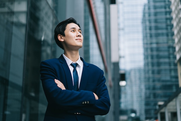 Young asian businessman with glass building