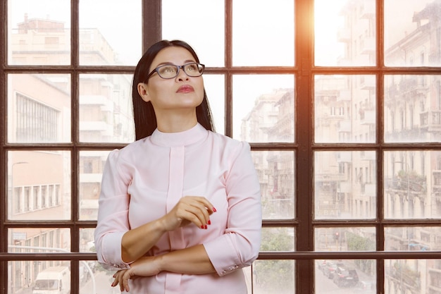 Young asian businesswoman indoors is looking up