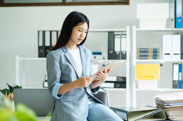 Young asian businesswoman working at office using laptop