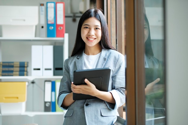 Young asian businesswoman working at office using laptop