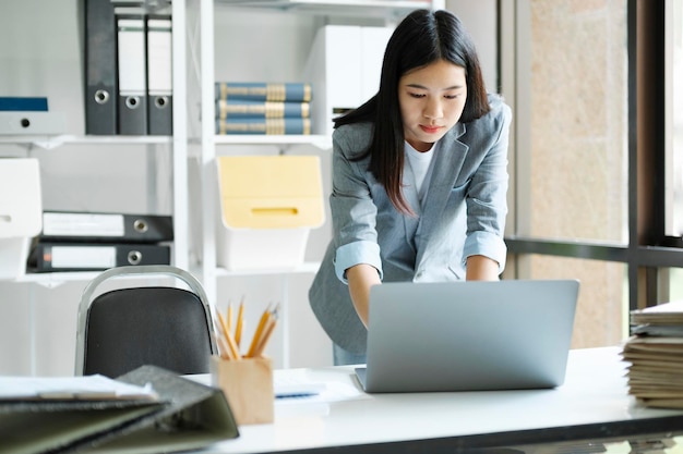 Young asian businesswoman working at office using laptop