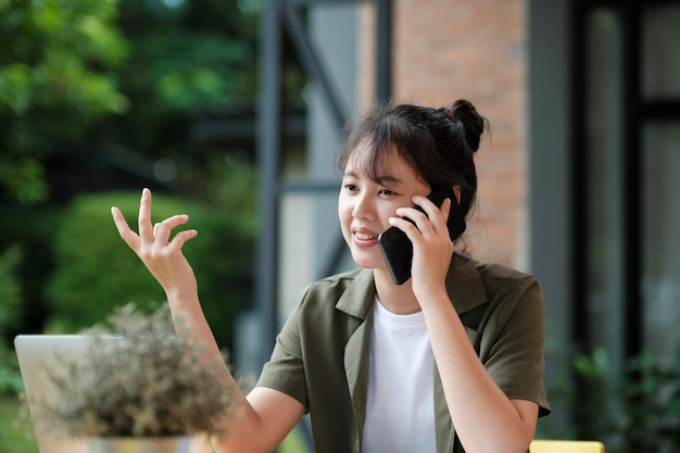 Young asian businesswoman working at office using mobile phonexA