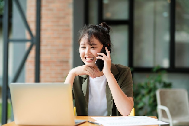 Young asian businesswoman working at office using mobile phonexA