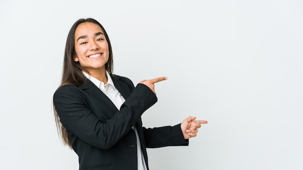 Young asian bussines woman isolated on white background excited pointing with forefingers away.