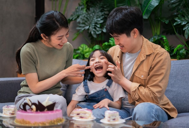 Young Asian couple celebrates their daughters birthday