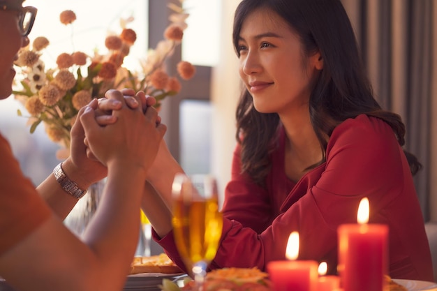 Young Asian couple eating dinner together