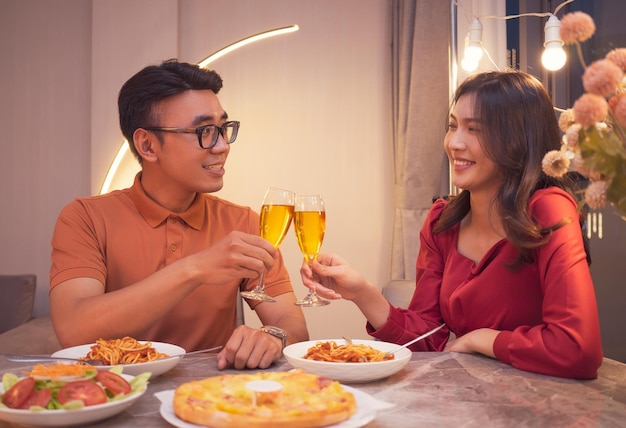 Young Asian couple eating dinner together