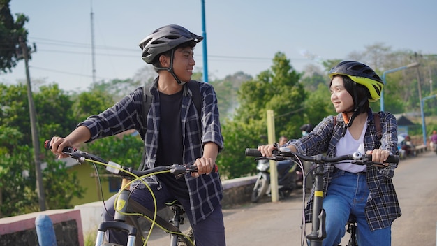 Young asian couple having rest after ride bicycle go to work