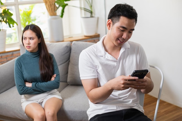 Young Asian couple at the man's side dishonest and disrespectful to his wife