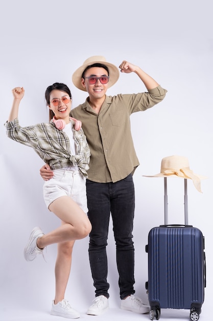 Young Asian couple posing on white background