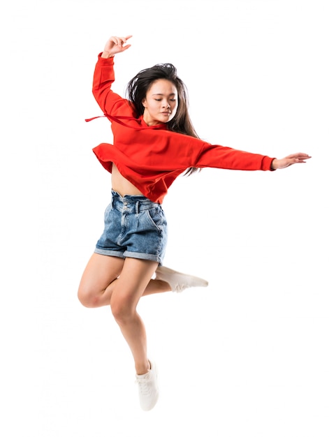 Young asian dancer over isolated white wall