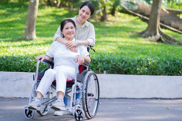 Young Asian daughter taking care of her disabled mother