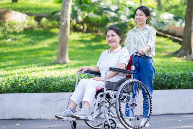 Young Asian daughter taking care of her disabled mother