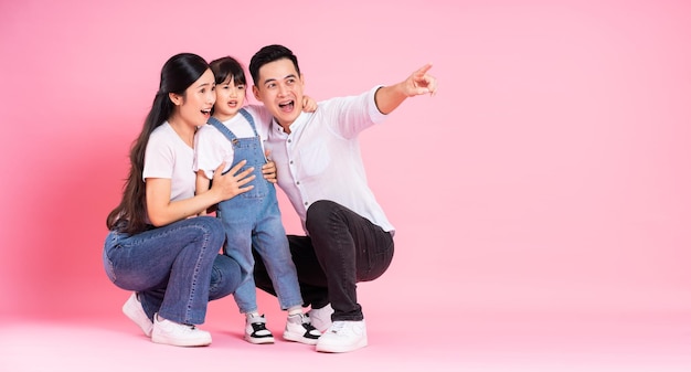 Young asian family image isolated on pink background