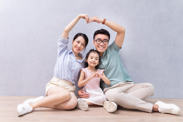 Young Asian family sitting on the floor