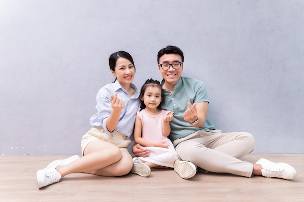 Young Asian family sitting on the floor