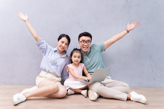 Young Asian family sitting on the floor