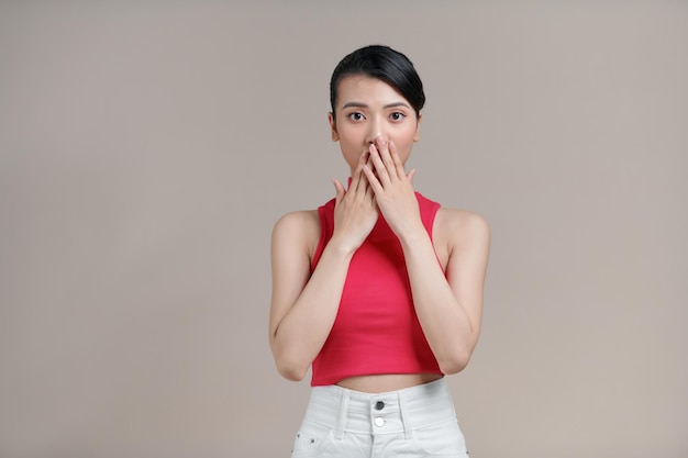 Young asian female amazed with happiness in positive shock cheering to good amazing news