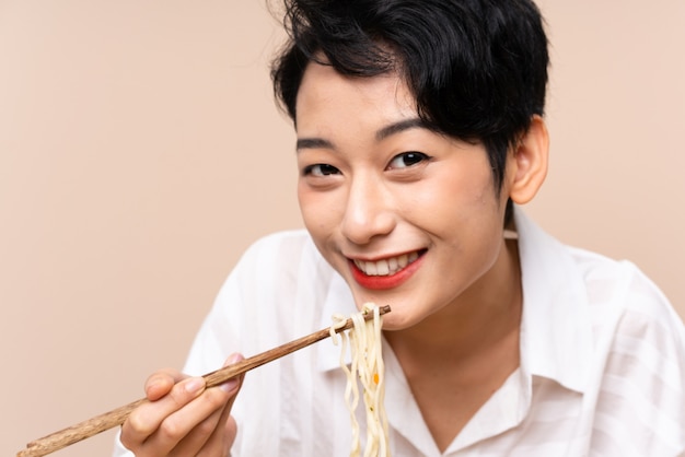 Young Asian girl in a table with bowl of noodles