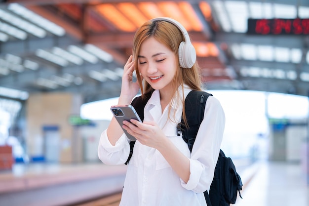 Young Asian girl waiting for the train at the station