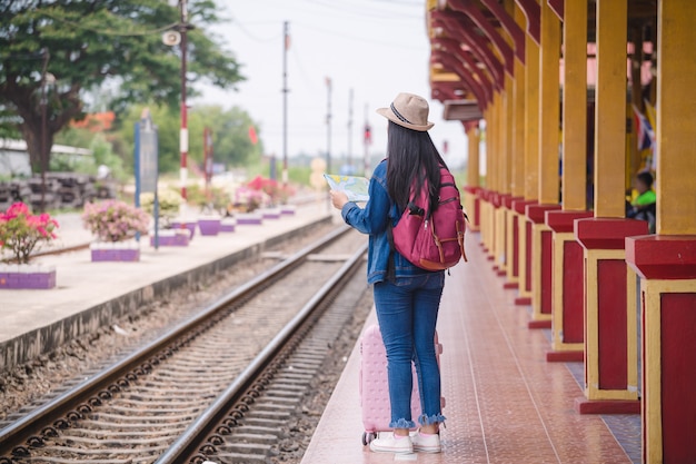  Young asian gril walking at train station before travel. 