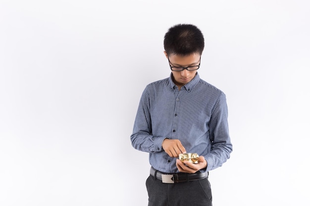 Young Asian male hands holding alarm clock in front of white background