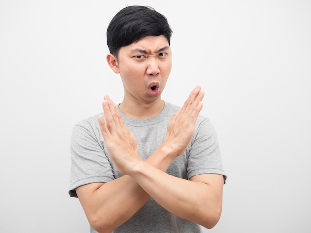 Young Asian man black shirt cross arm disagree say no looking at camera on white isolate background