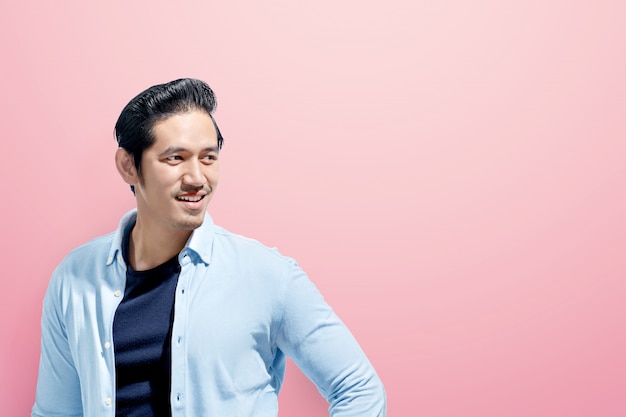 Young asian man in casual clothes standing