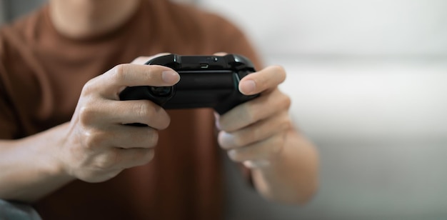 Young Asian man gamer wearing virtual reality touching air during the VR experience Future home technology player hobby playful enjoyment concept